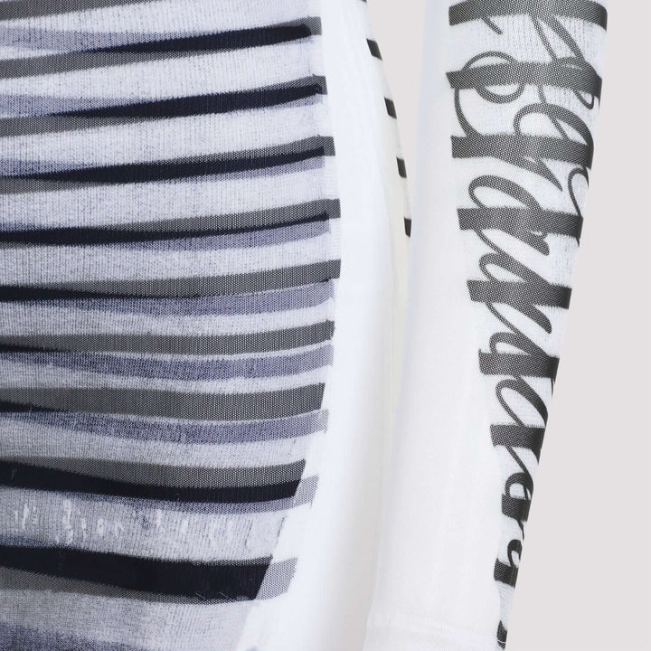 Close-up of a fabric with black and white stripes and a brand logo.