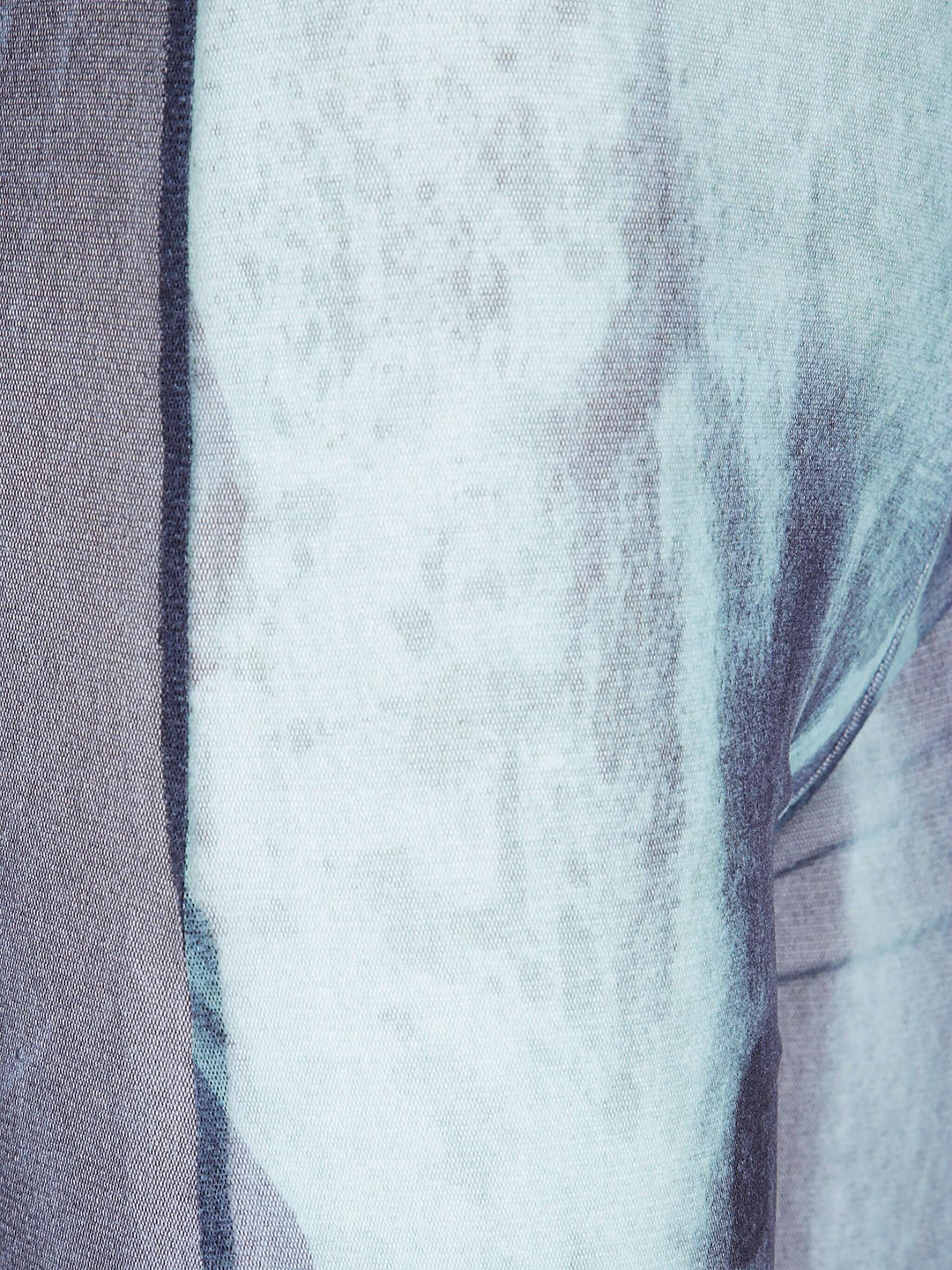 Close-up of a textured fabric with a gradient from gray to white.