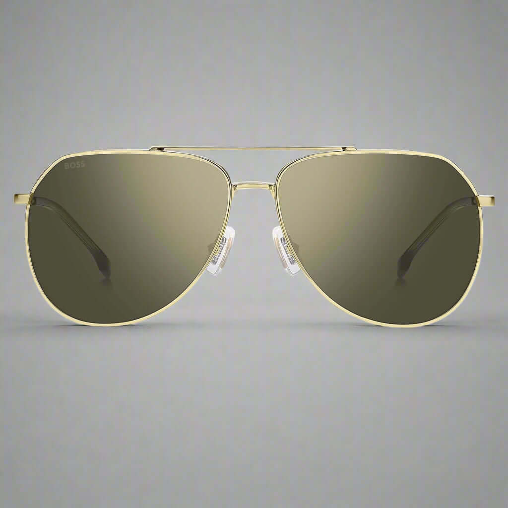 Gold-framed sunglasses with dark lenses on a white background