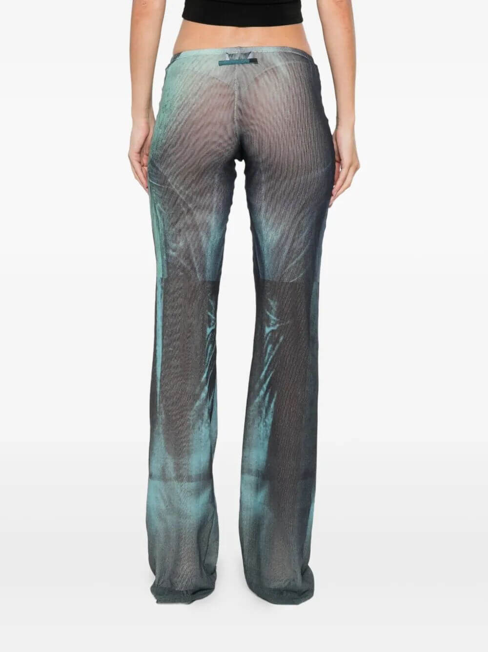 Person wearing a pair of patterned pants on a white background