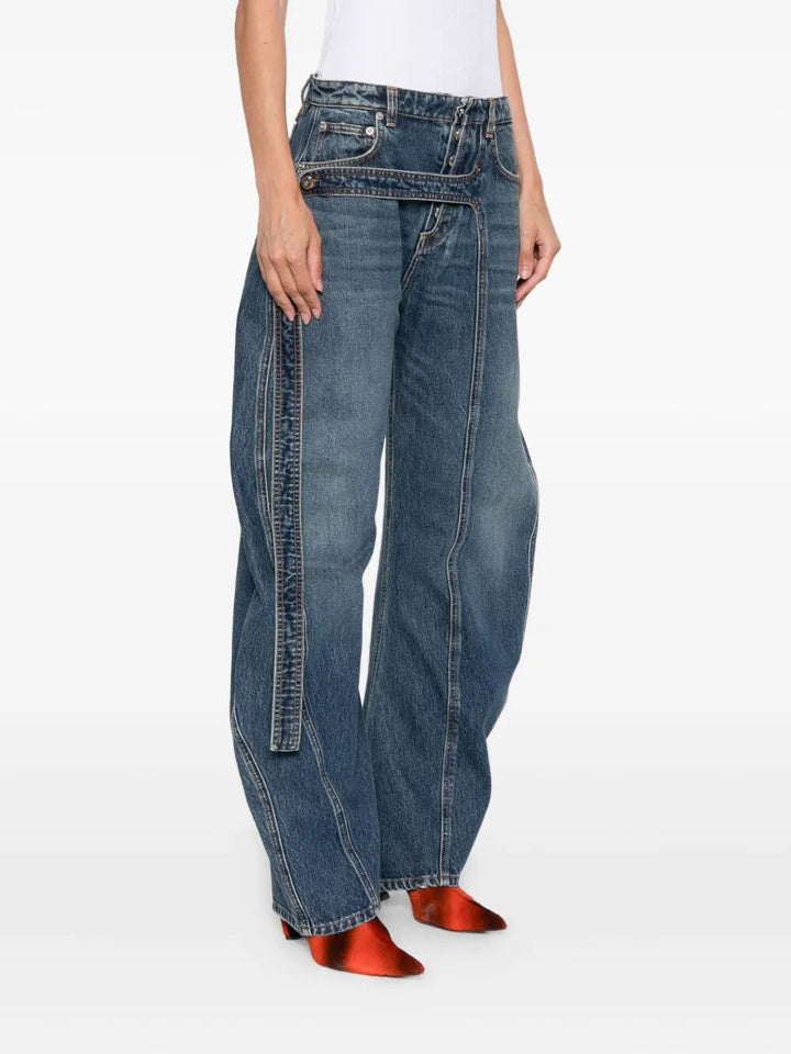 Person wearing blue jeans on a white background