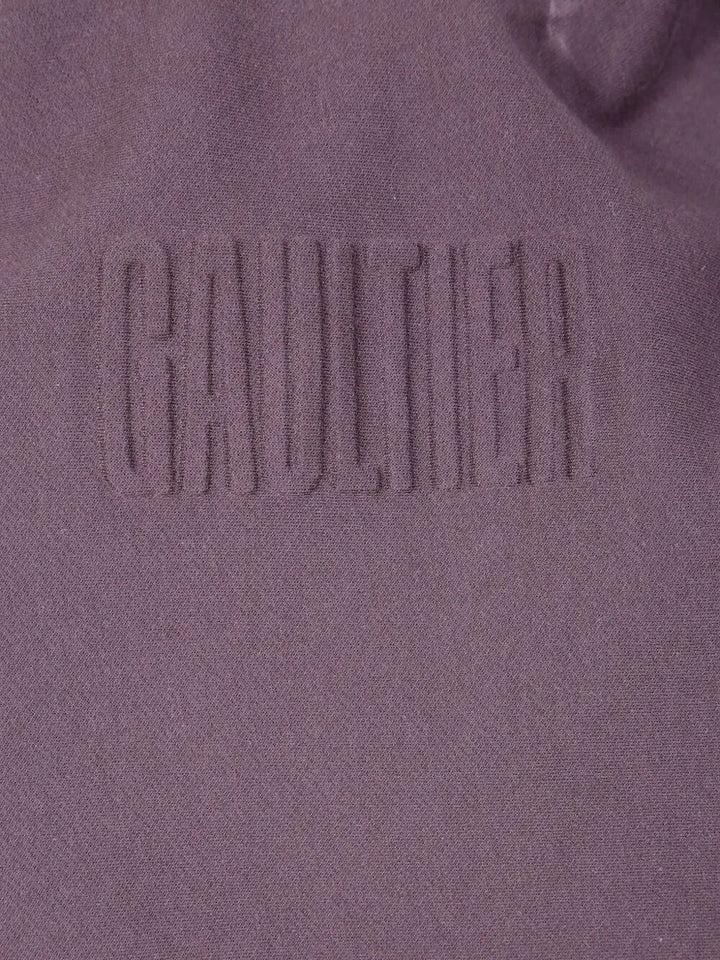 Close-up of a textured surface with 'Gaultier' branding.