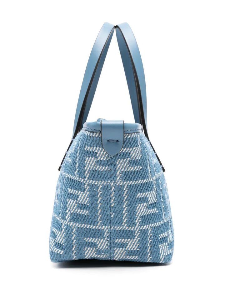 Blue patterned handbag with a strap on a white background