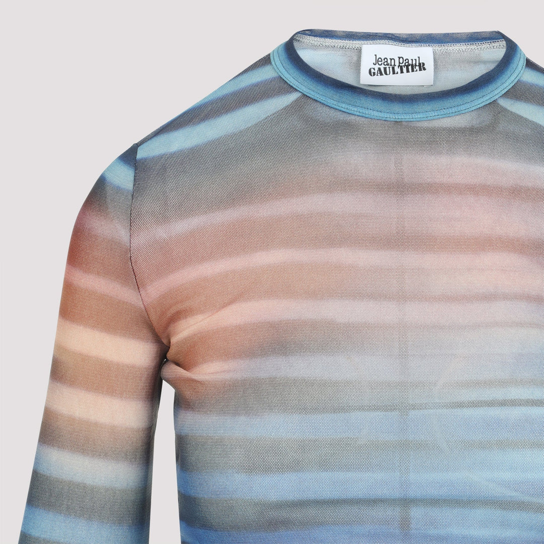 Sheer striped shirt with gradient colors on a light gray background, featuring the brand 'Jean Paul Gaultier'.