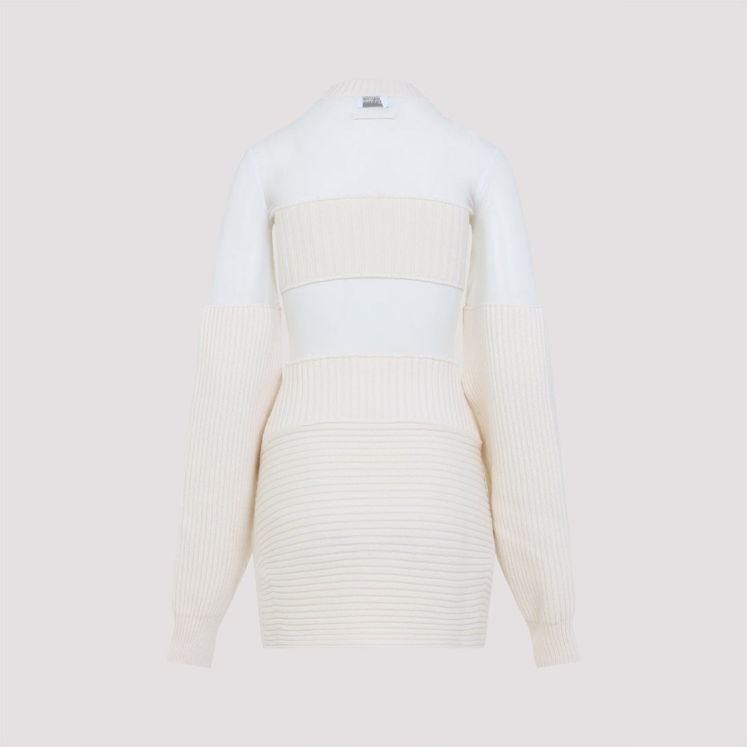White ribbed sweater with beige accents on a light beige background