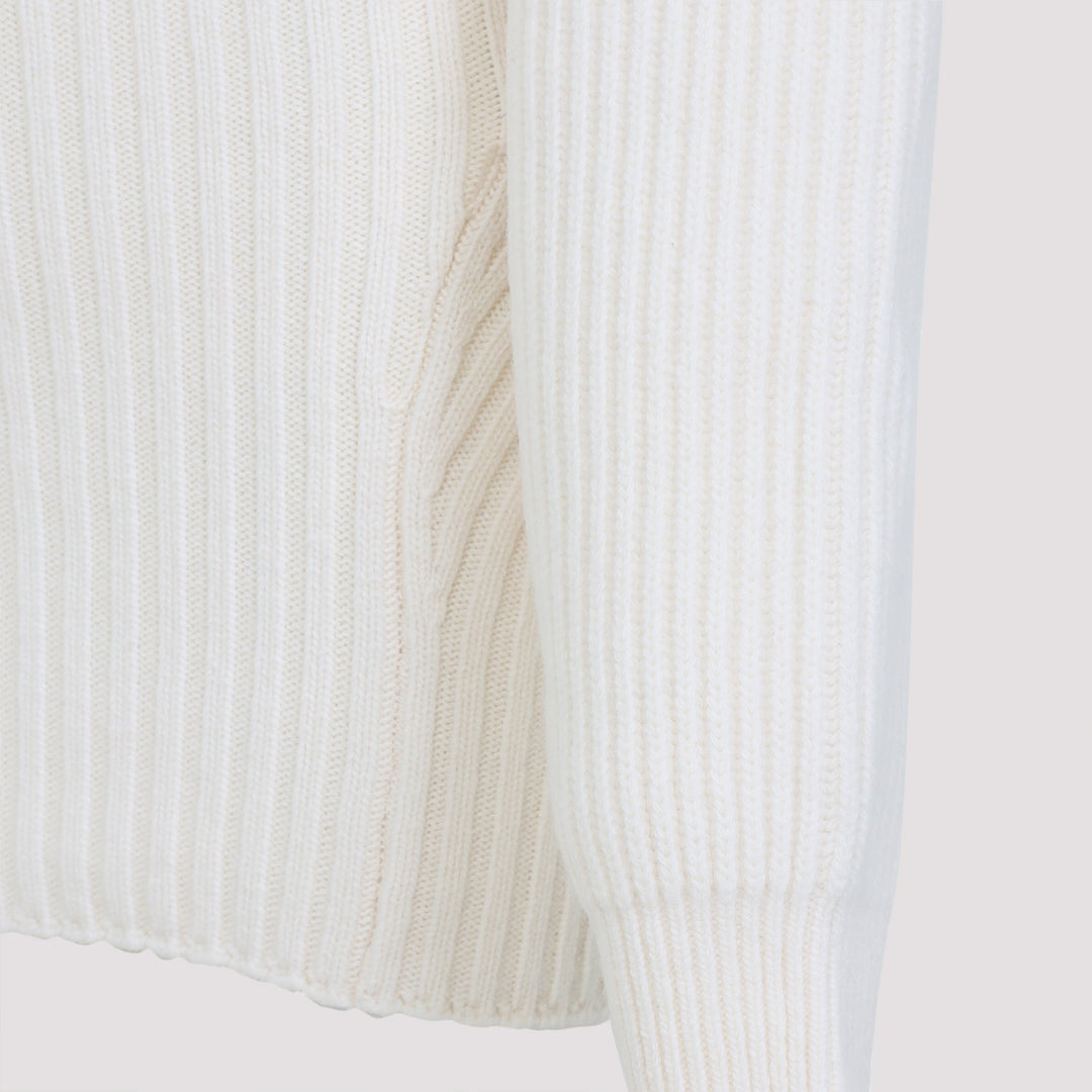Close-up of a ribbed knit fabric in white on a light gray background