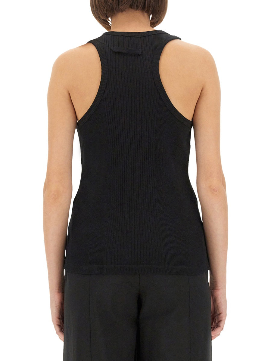Person wearing a black ribbed tank top on a white background