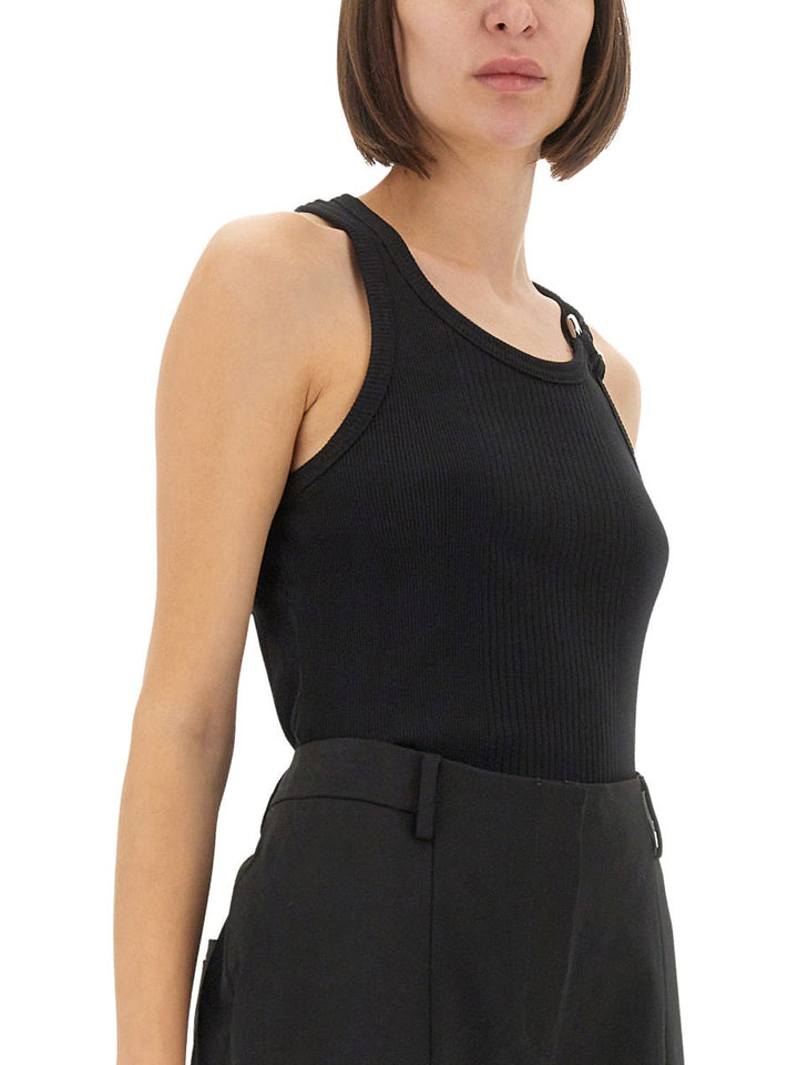 Person wearing a black sleeveless top and black pants on a white background