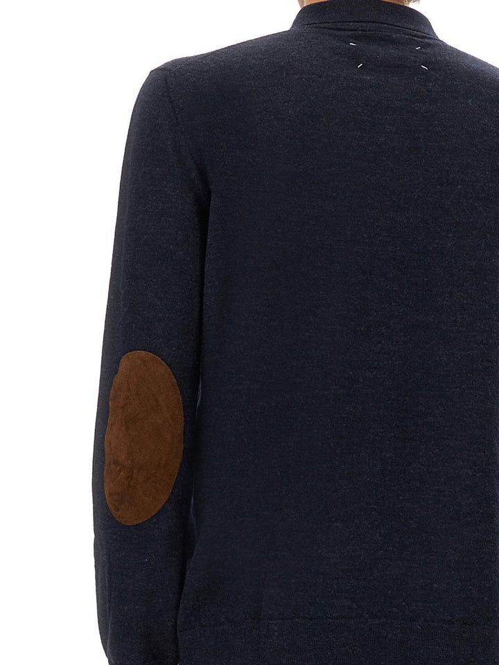 Navy blue jacket with brown elbow patches on a white background
