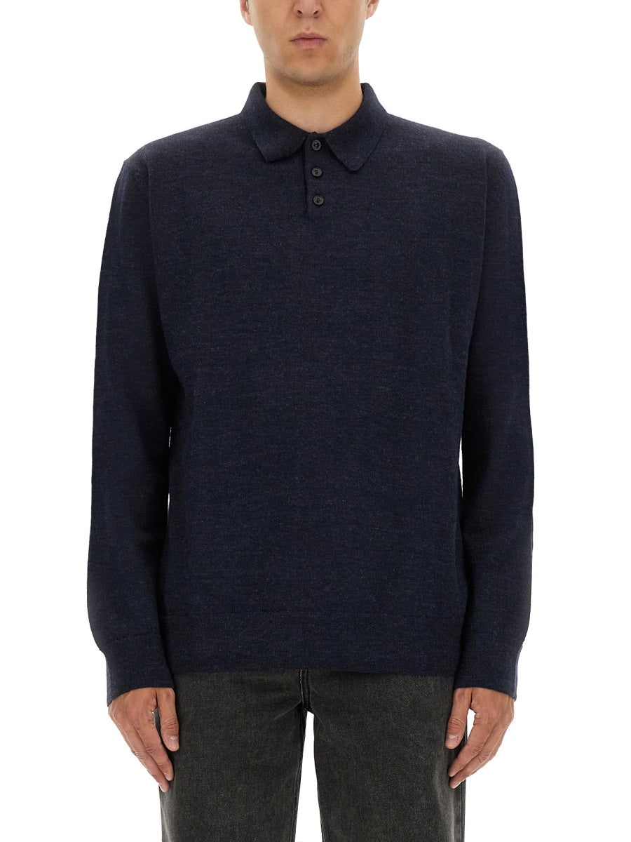 Man wearing a navy blue sweater with a collar on a white background