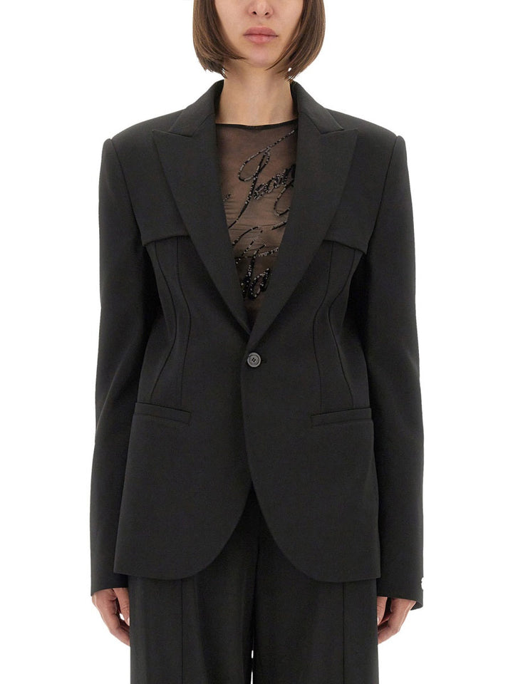 Black suit jacket worn by a person on a white background