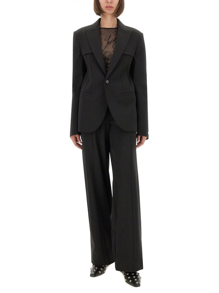 Person wearing a black suit with a white background