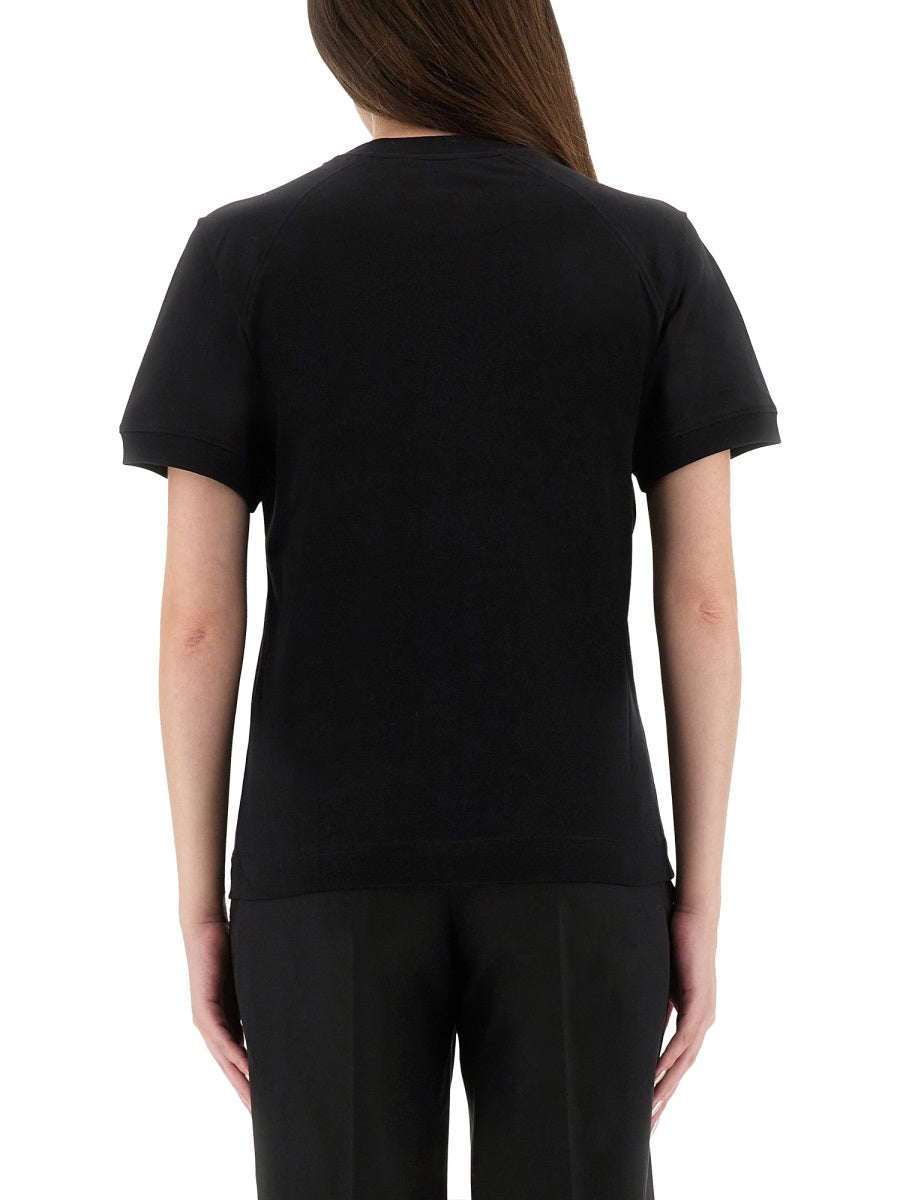Person wearing a black t-shirt and pants on a white background