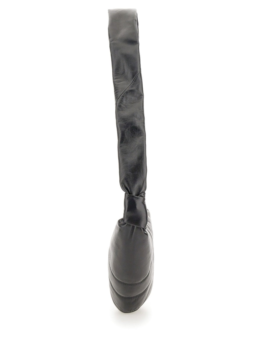 Black rubber boot with a strap on a white background