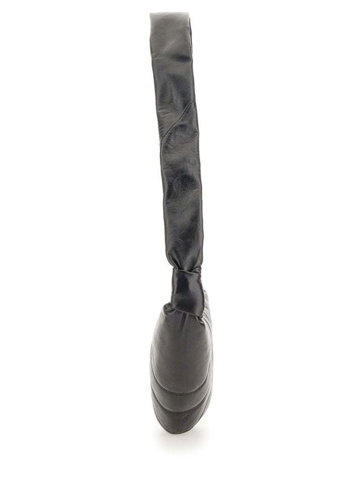 Black rubber boot with a strap on a white background