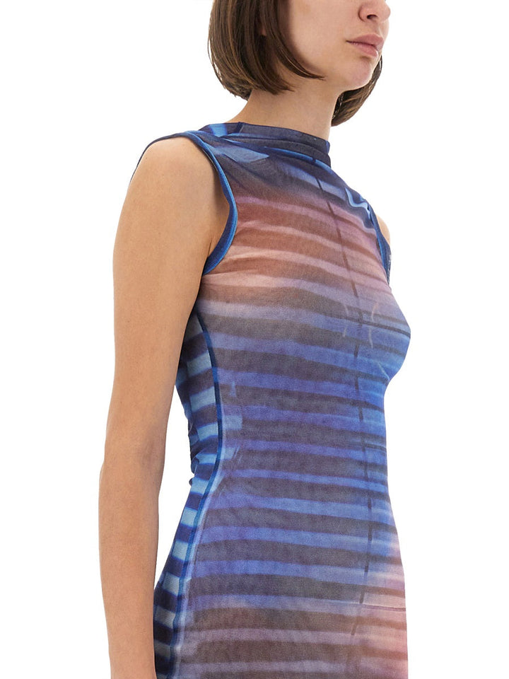 Woman wearing a sleeveless dress with multicolor stripes on a white background