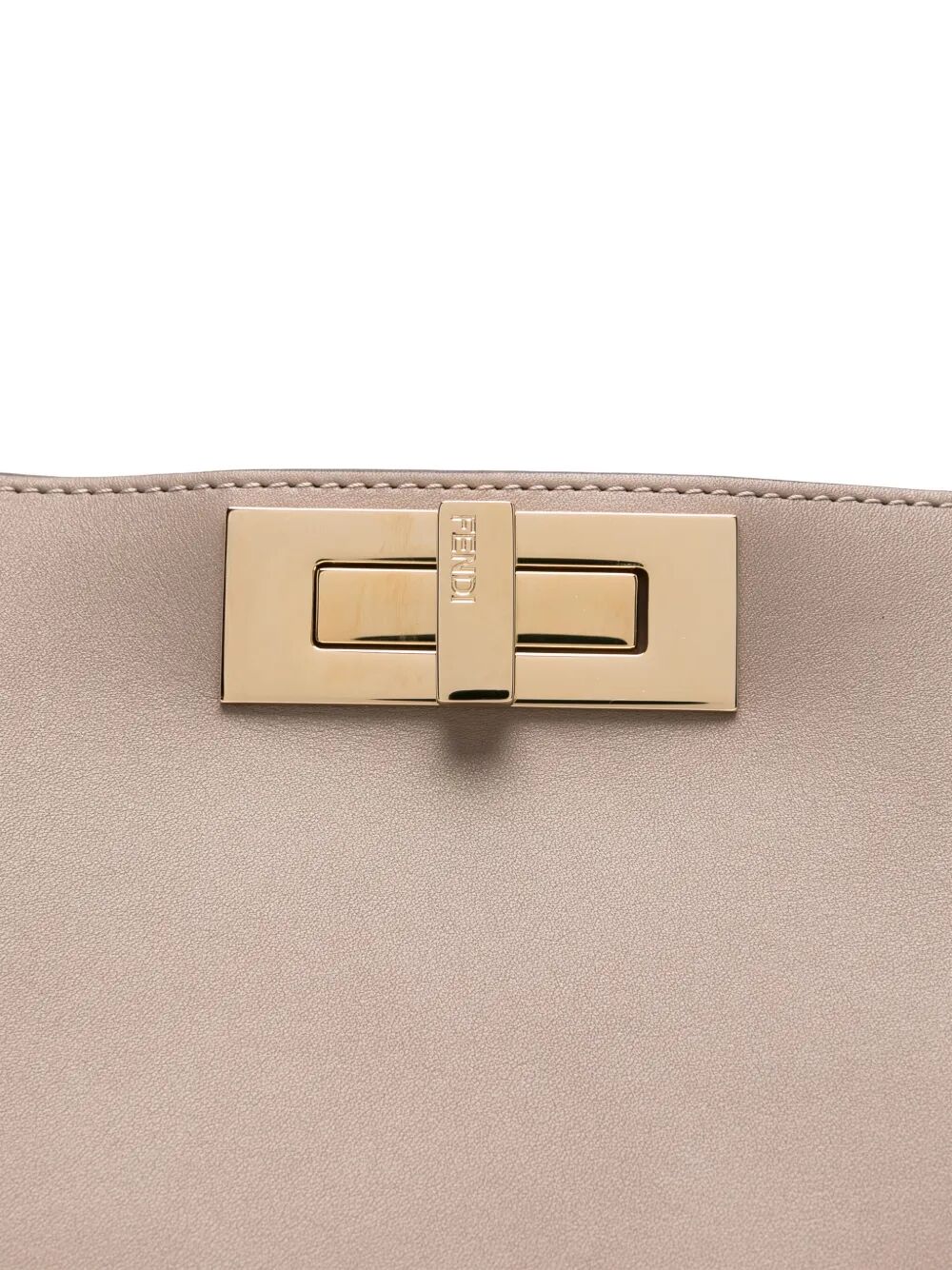 Close-up of a beige handbag with a gold clasp on a white background