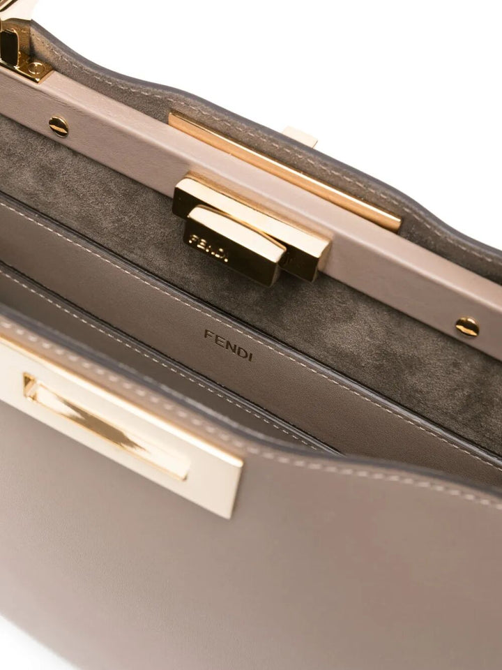 Close-up of a Fendi handbag with gold hardware on a white background
