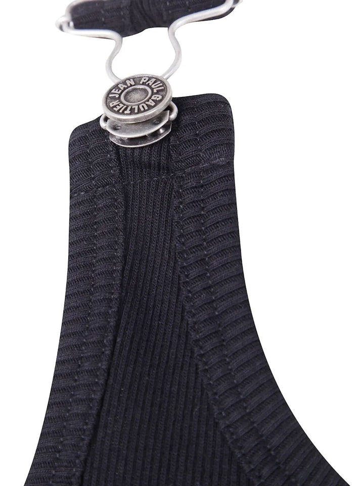 Black ribbed garment on a hanger with a visible brand tag.