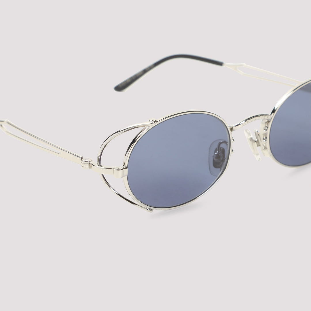 Round sunglasses with silver frame and blue lenses on a light gray background