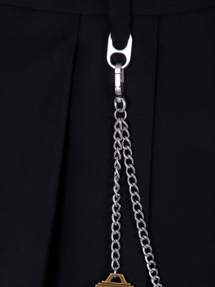 Close-up of a silver chain with a pendant on a black background