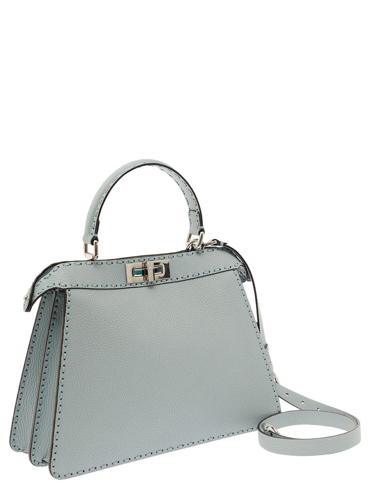 Light blue handbag with a strap on a white background