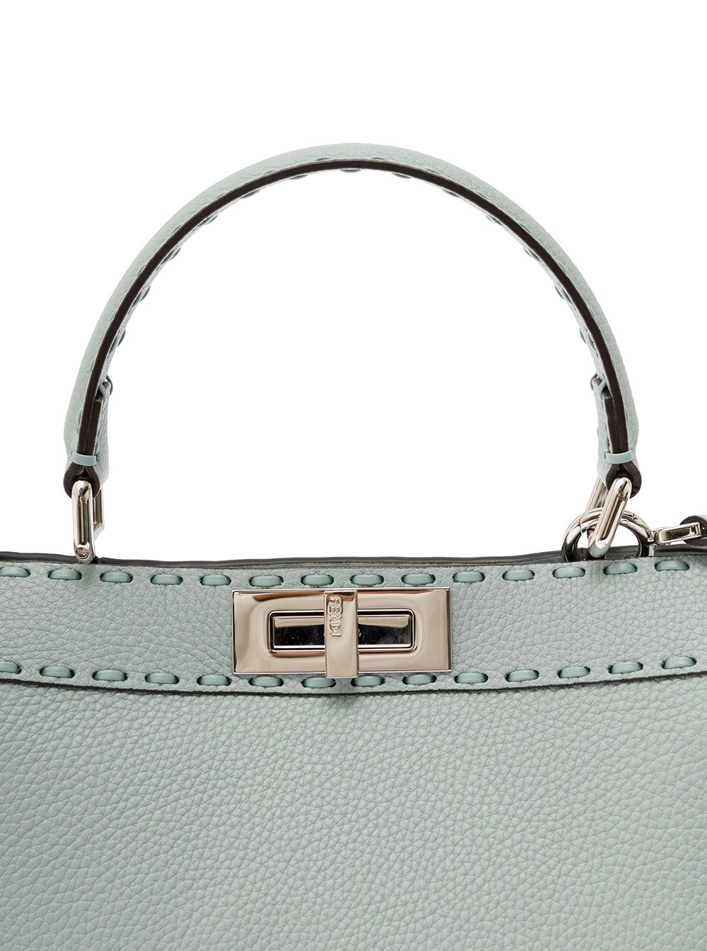 Close-up of a light blue handbag with a silver handle and clasp on a white background