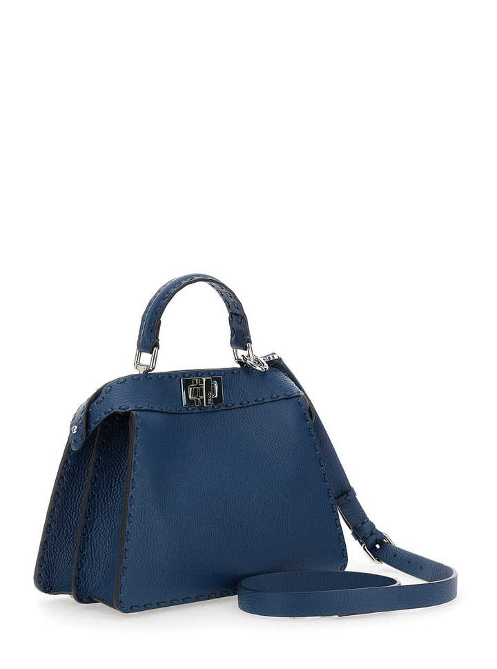 Blue handbag with a strap on a white background