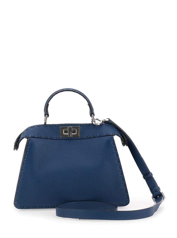Blue handbag with a strap on a white background