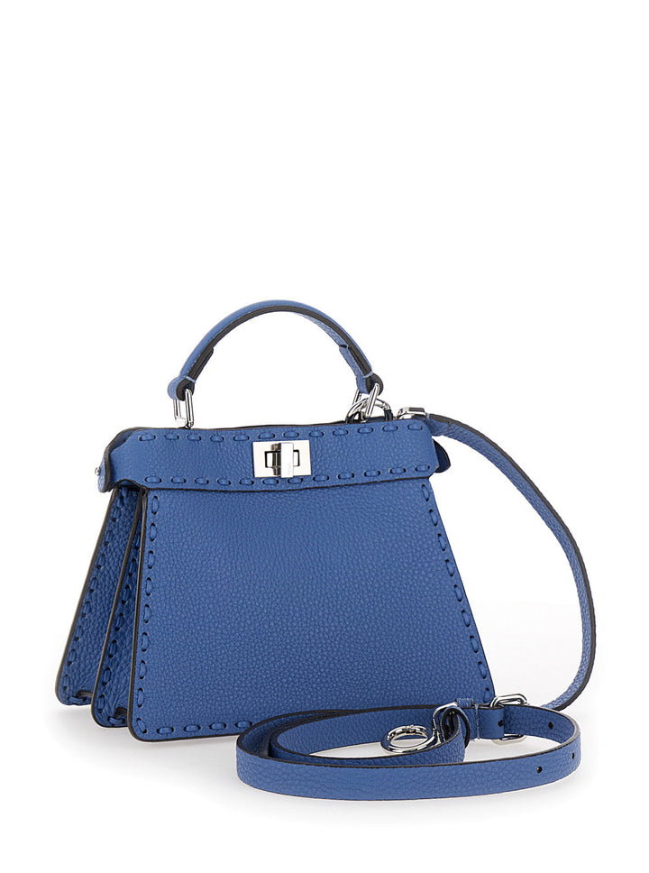 Blue handbag with a strap on a white background