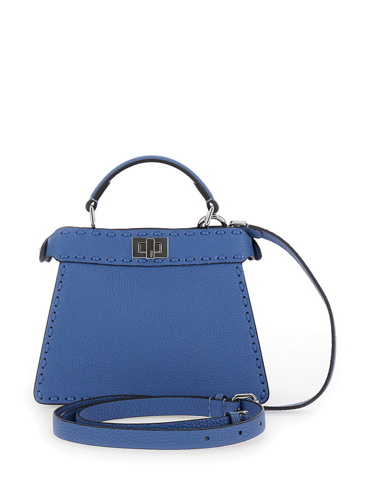 Blue handbag with a strap on a white background