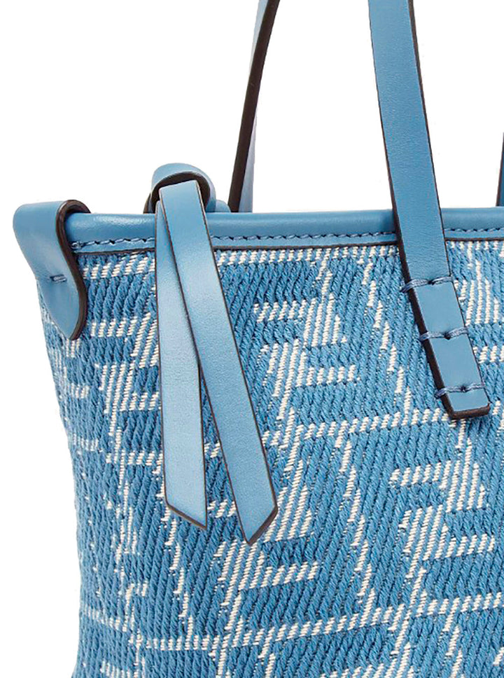 Blue woven handbag with leather straps on a white background