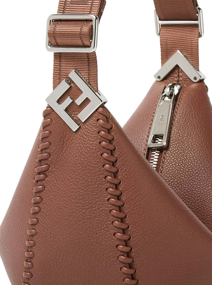 Brown leather bag with silver zippers and logo on a white background