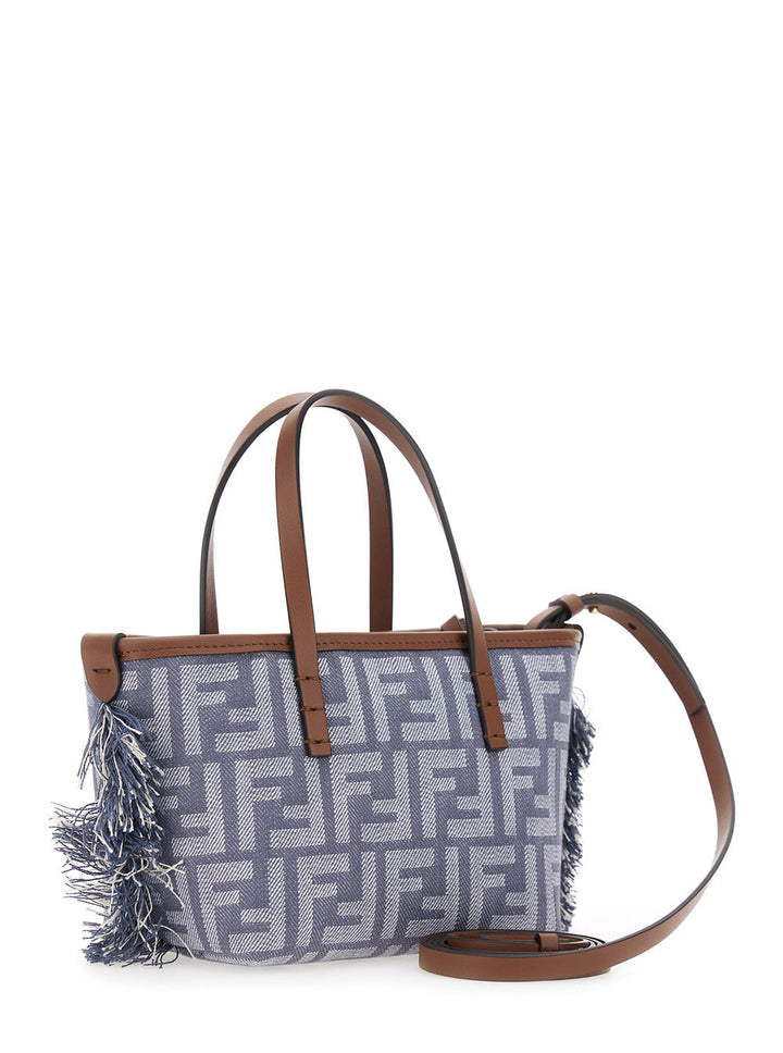 Gray handbag with brown leather straps and fringes on a white background