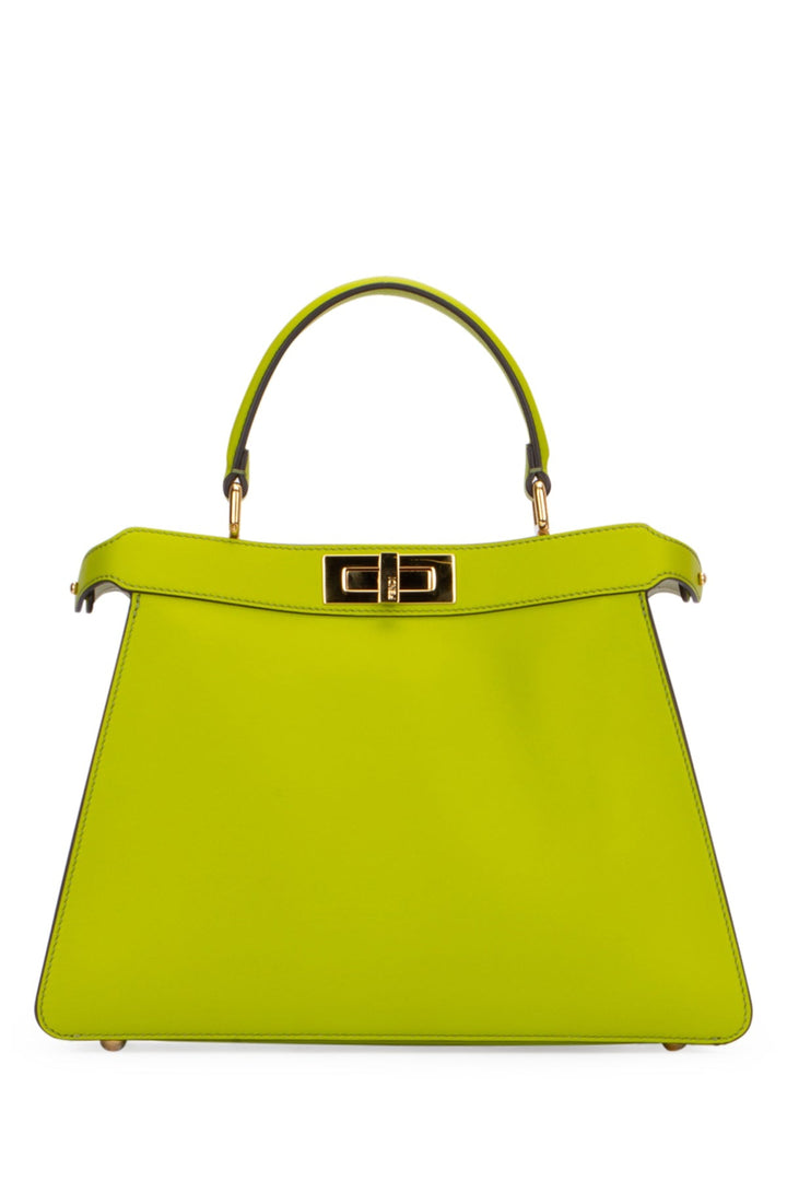 Green handbag with gold hardware on a white background