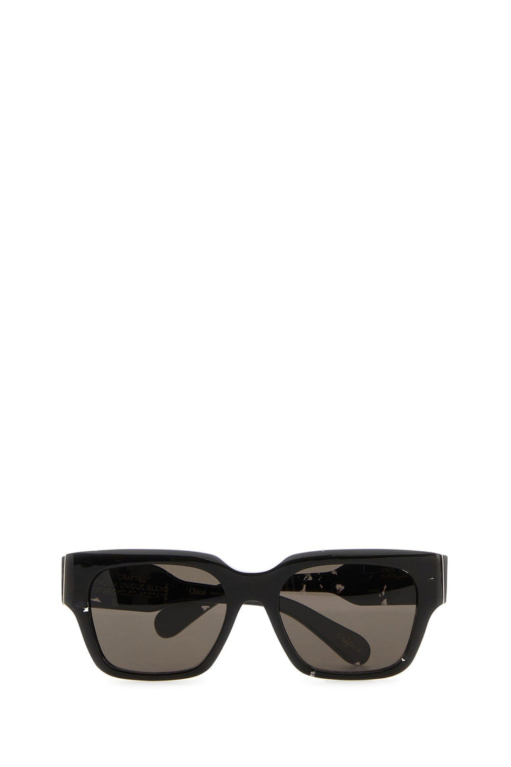 Black sunglasses with dark lenses on a white background