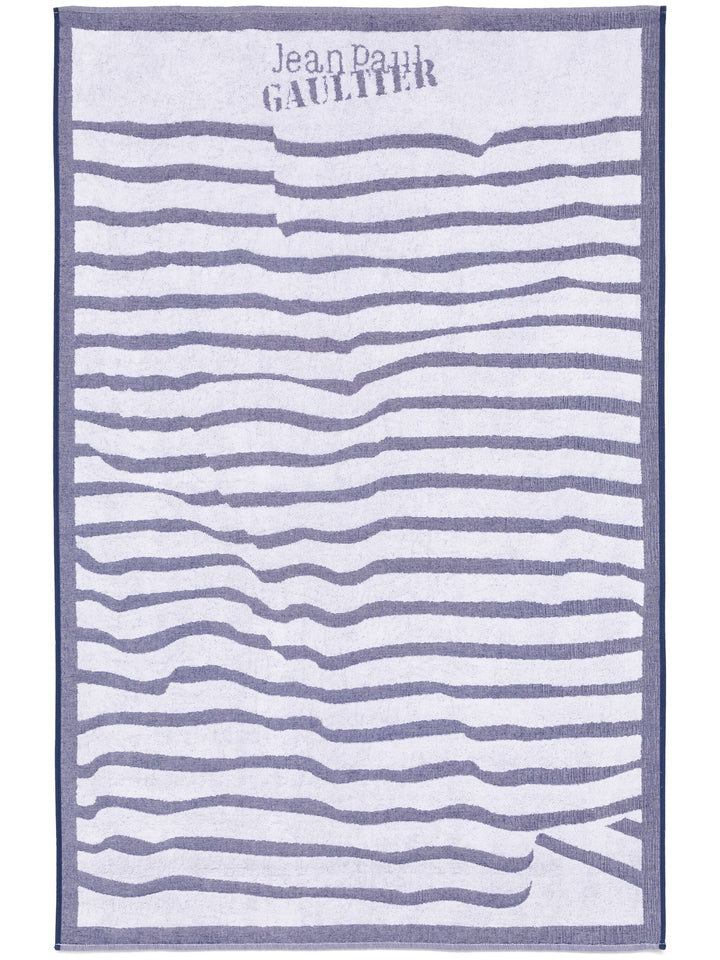 Striped towel with 'Jean Paul Gaultier' branding on a white background