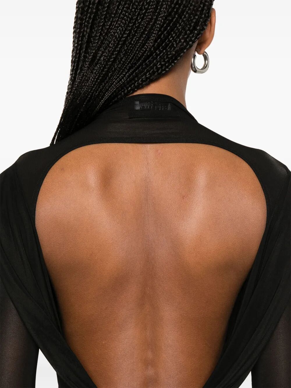 Black dress with open back on a white background