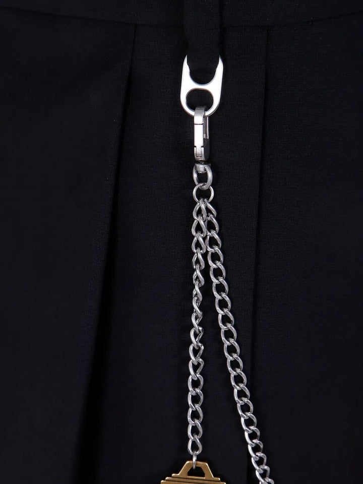 Close-up of a silver chain with a pendant on a black background