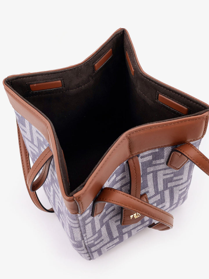 Tote bag with brown leather straps and geometric pattern on a white background