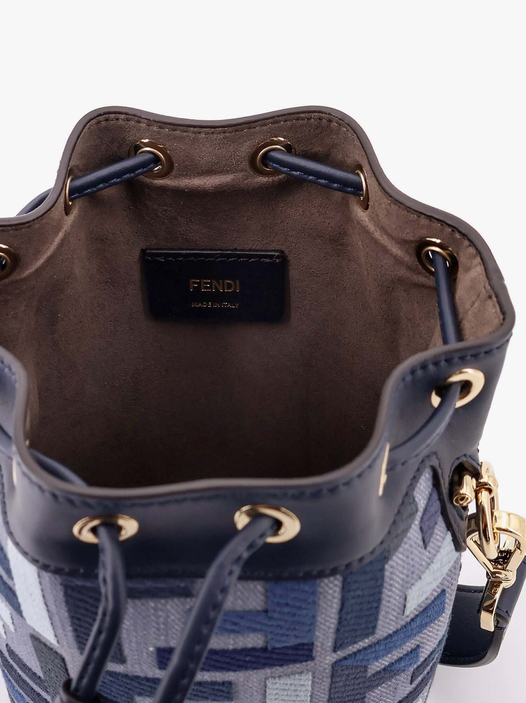 Fendi bucket bag with blue patterned exterior and brown interior on a white background