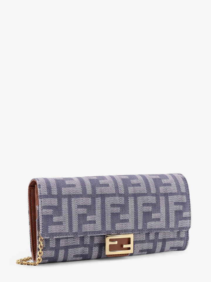 Blue patterned handbag with gold accents on a white background