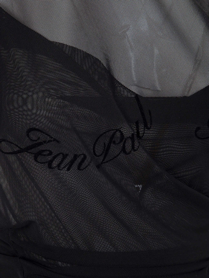 Black fabric with 'Jean Paul' embroidery on a textured background