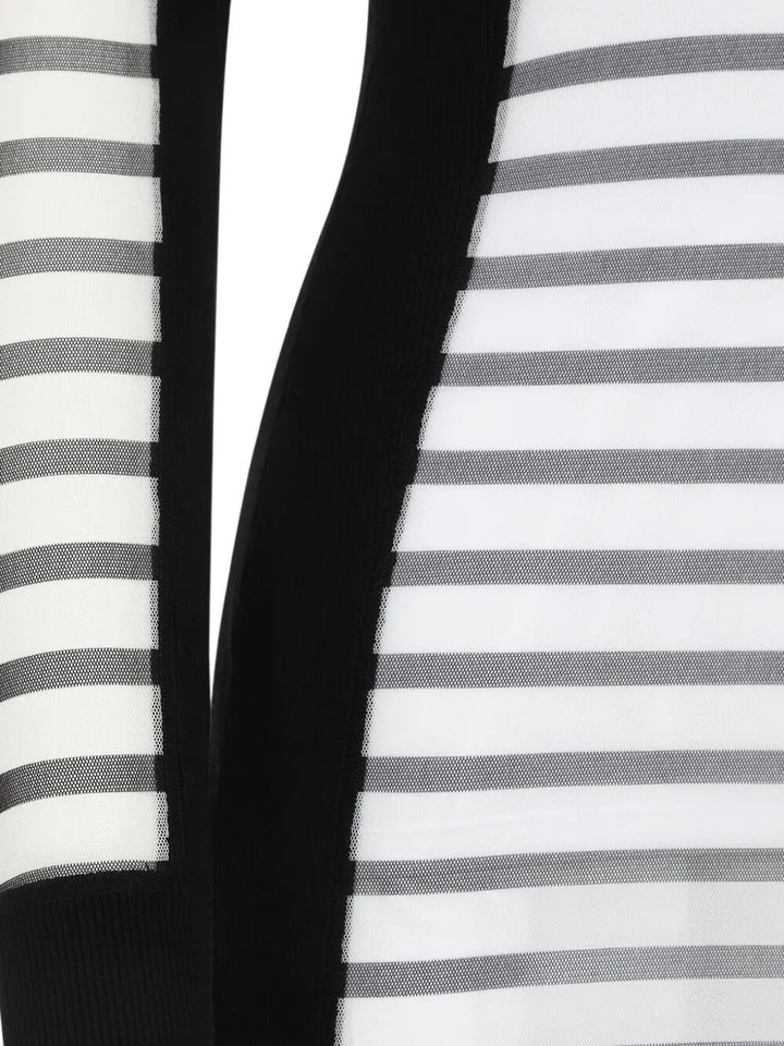 Close-up of a black and white striped fabric with a solid black section.