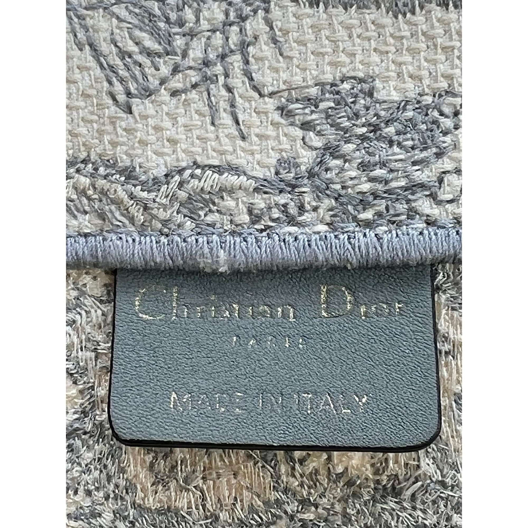Close-up of a textured fabric with a brand label on a white background