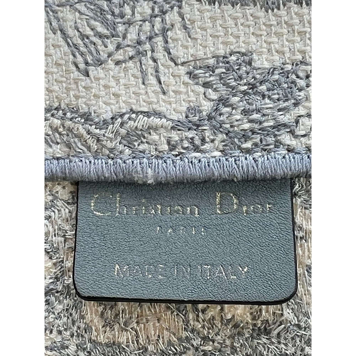 Close-up of a textured fabric with a brand label on a white background
