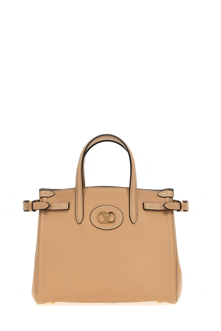 rotating brown leather handbag