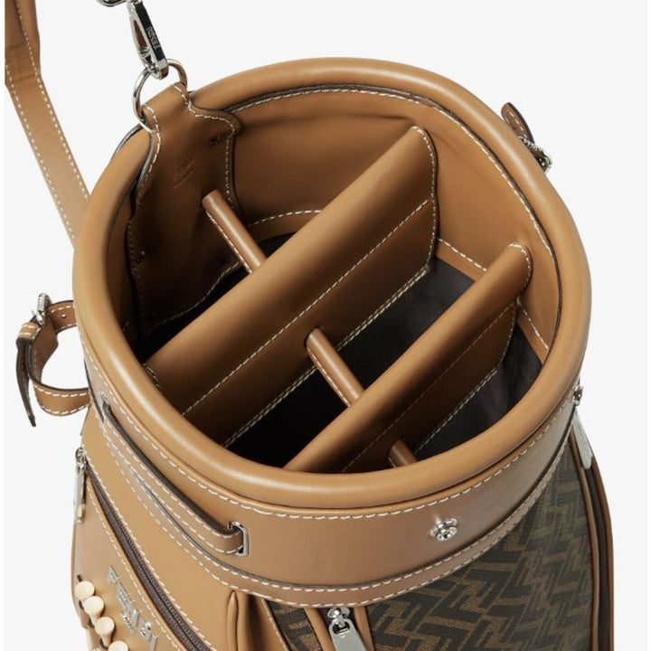 Close-up of a brown leather golf bag with visible brand logo.