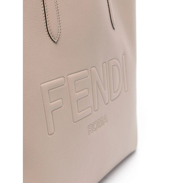 Beige leather surface with 'Fendi Roma' embossed text on a white background