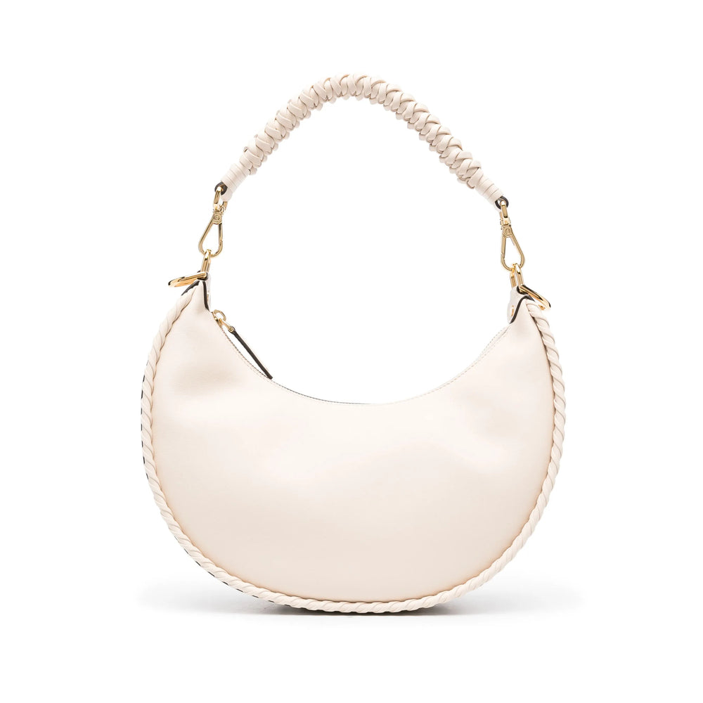 White handbag with a beaded handle on a white background